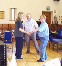 Rachel and Carole help Kevin escape from the plastic cage....and do a dance of joy